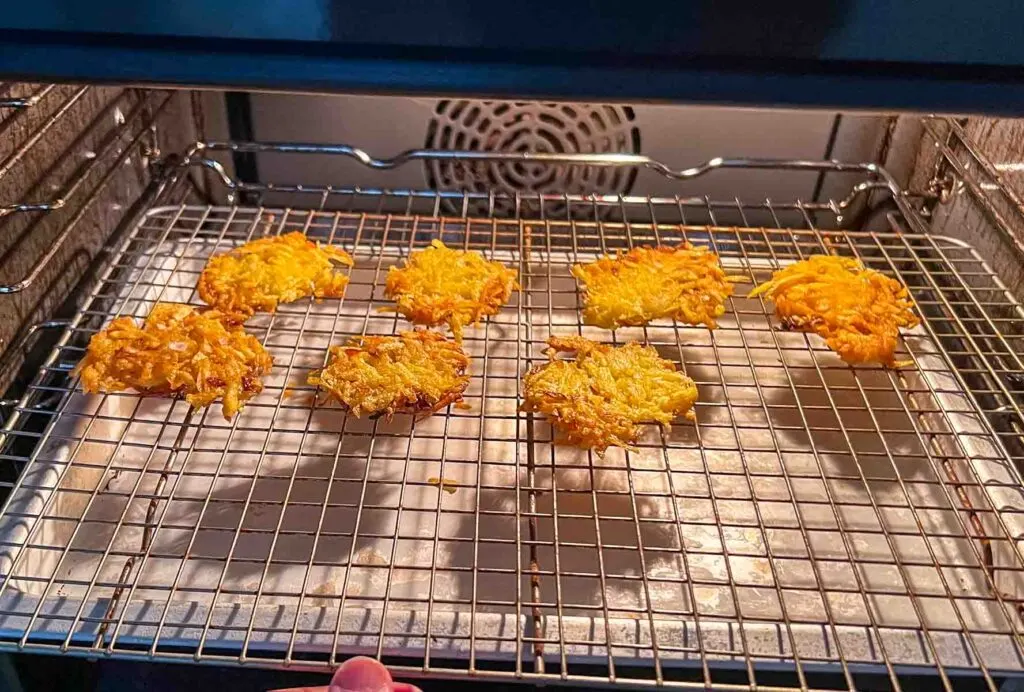 Finished latkes warming on a cooling rack in the oven