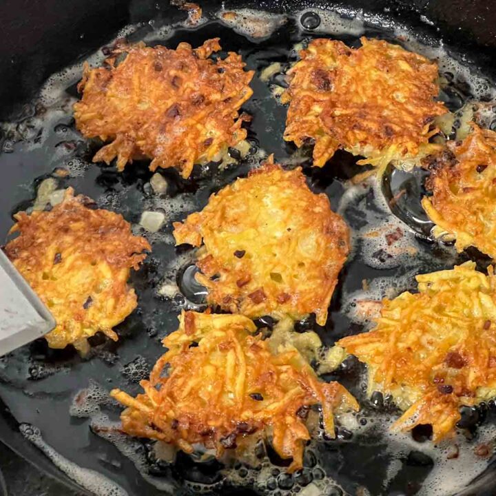 Latkes almost finished in a cast iron pan