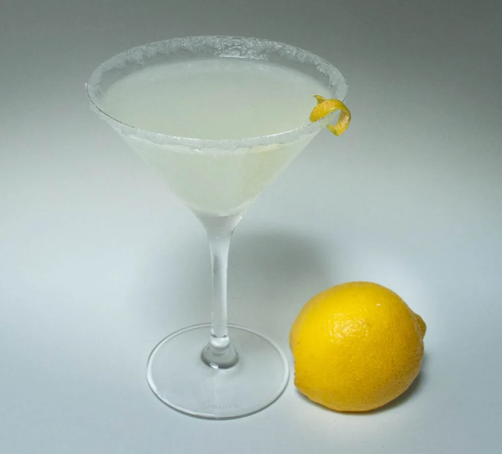 Lemon Drop Martini with a Lemon at its base on the right