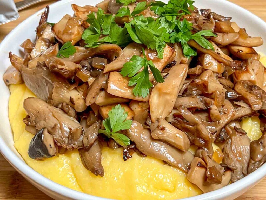 Polenta and cheese with sauteed mushrooms on top