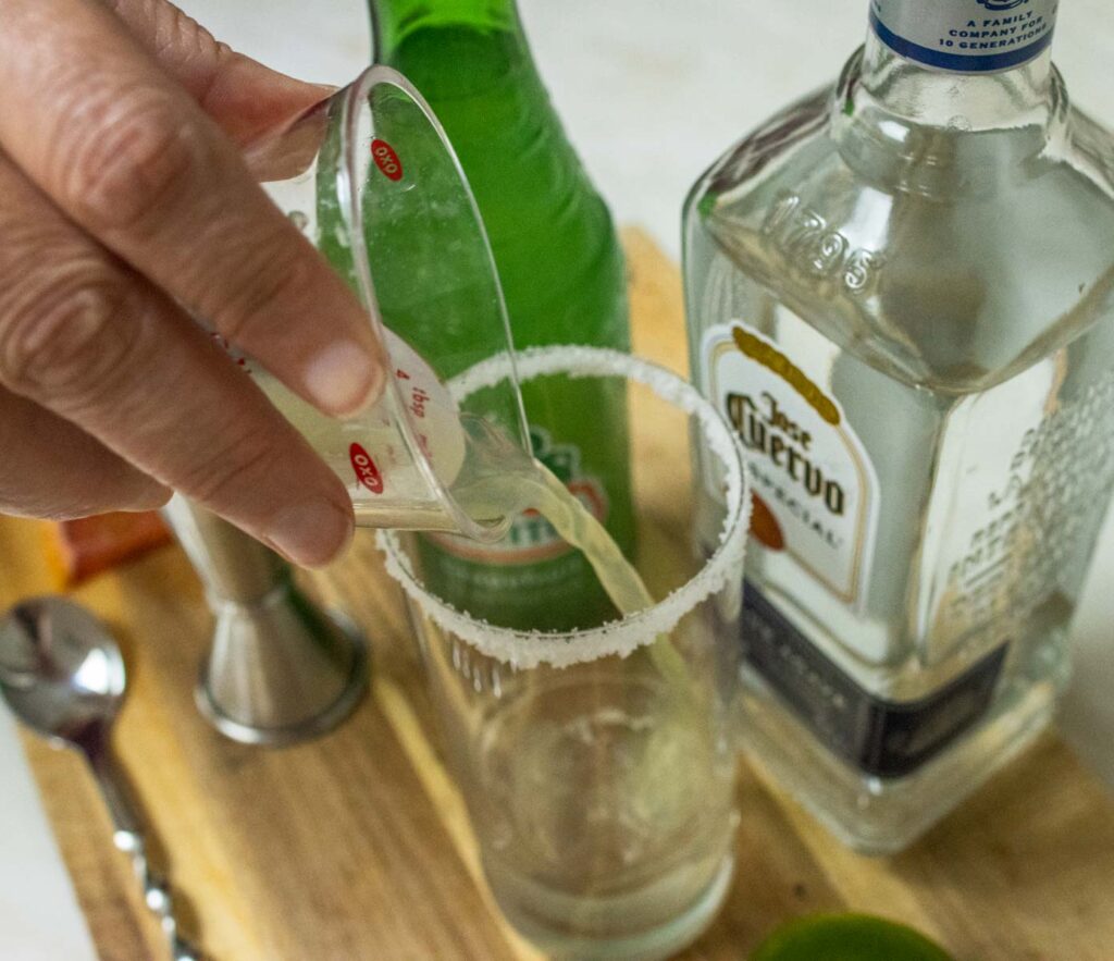 Pouring Lime Juice for a Paloma Cocktail