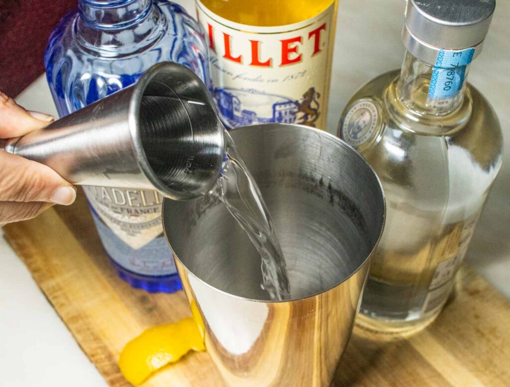 Pouring Vodka into Vesper Martini