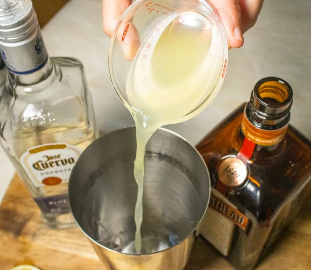 Adding Lime Juice to Margarita Cocktail