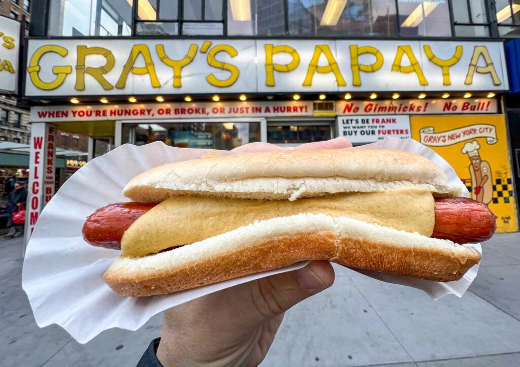 Hot Dog in front of Grays Papaya in New York