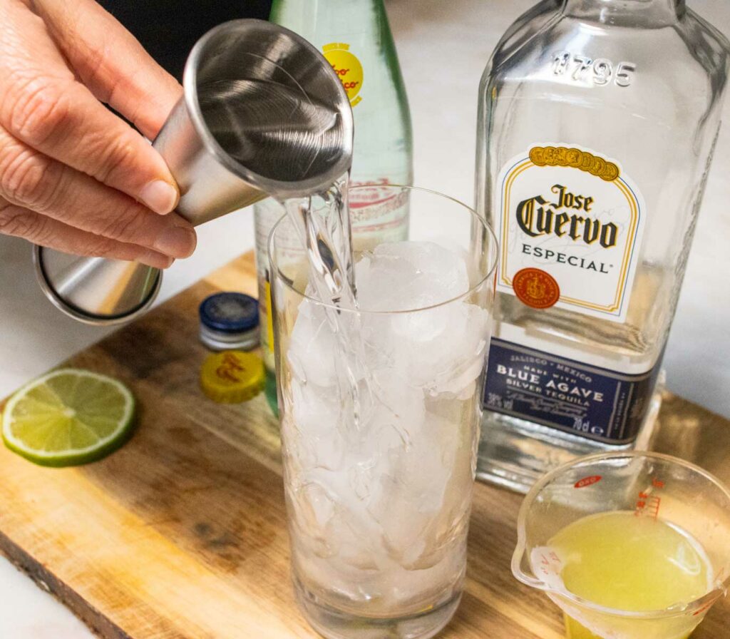 Pouring Tequila into Ranch Water