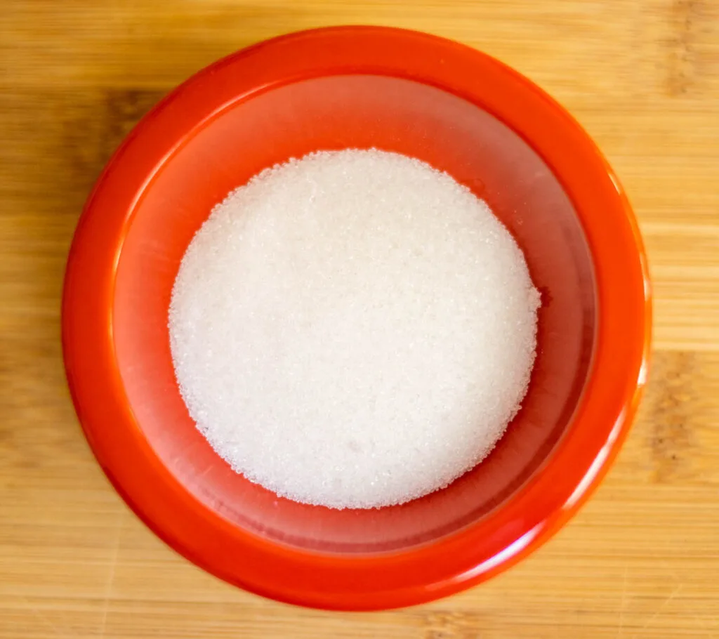 White Sugar in a Red Bowl