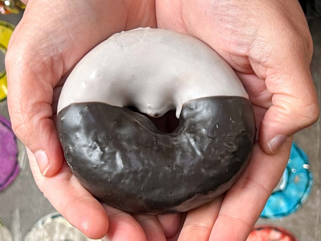 Black and White Donut in Hands at Doughnut Plant in New York City