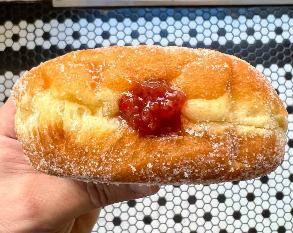 Hand Filled Jelly Donut in Air at Orwashers in New York City