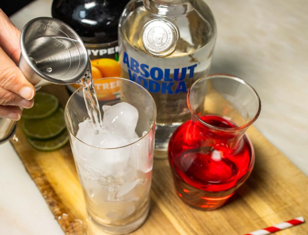 Pouring Liquor into a Woo Woo Cocktail