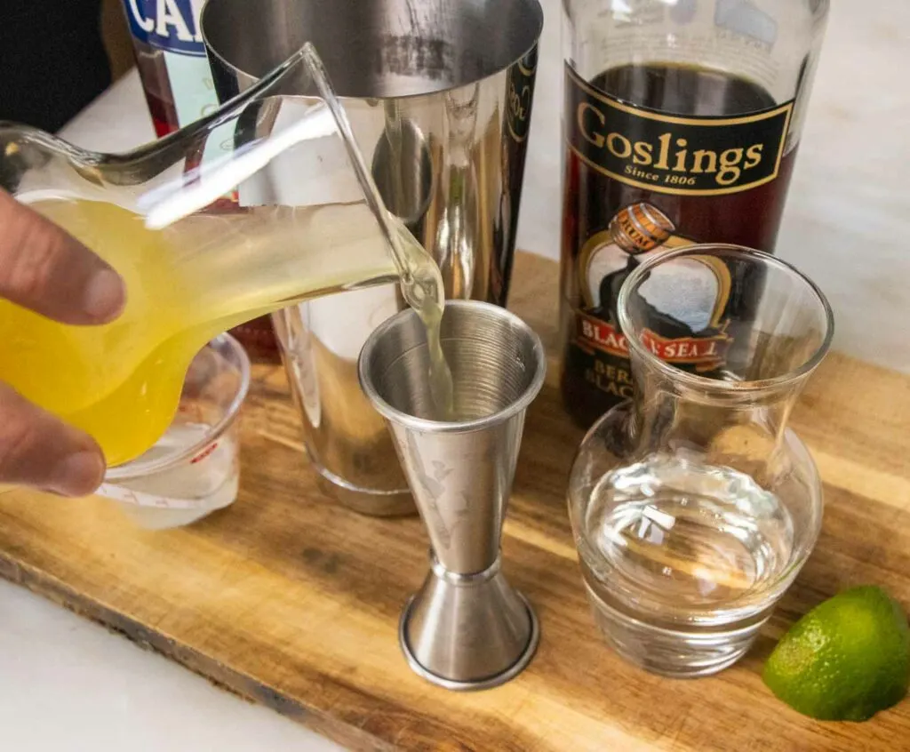 Measuring Pineapple Juice for a Jungle Bird Cocktail