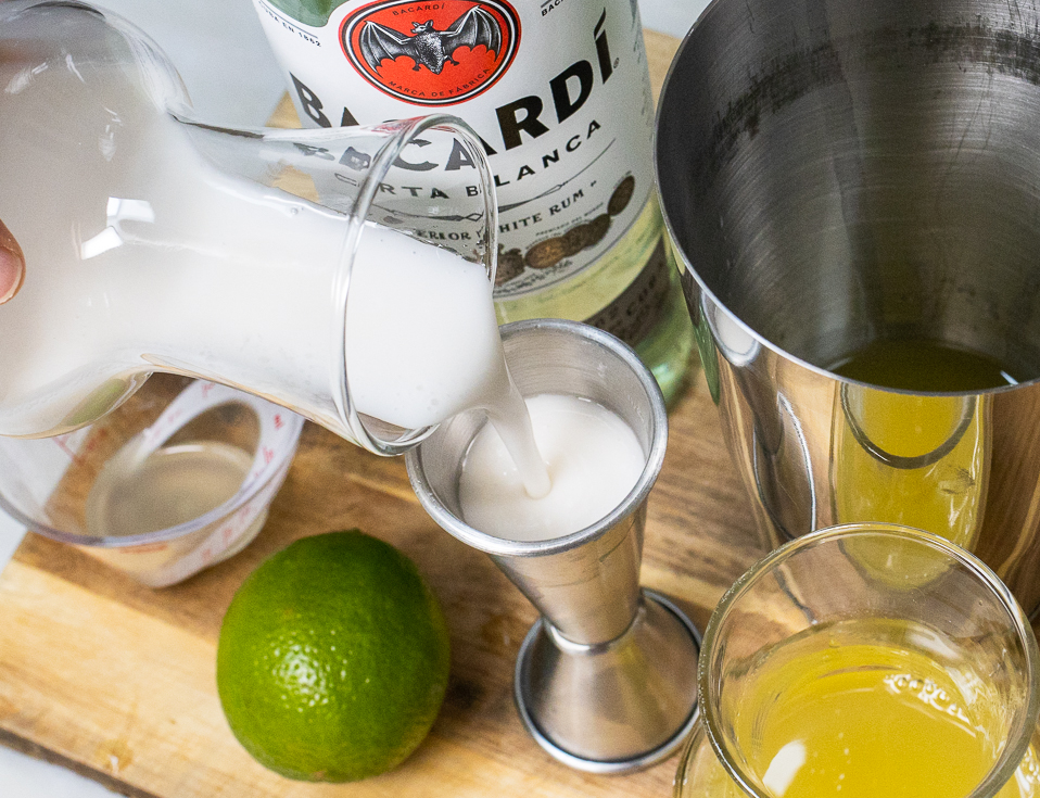 Pouring Cream of Coconut into Pina Colada Shaker