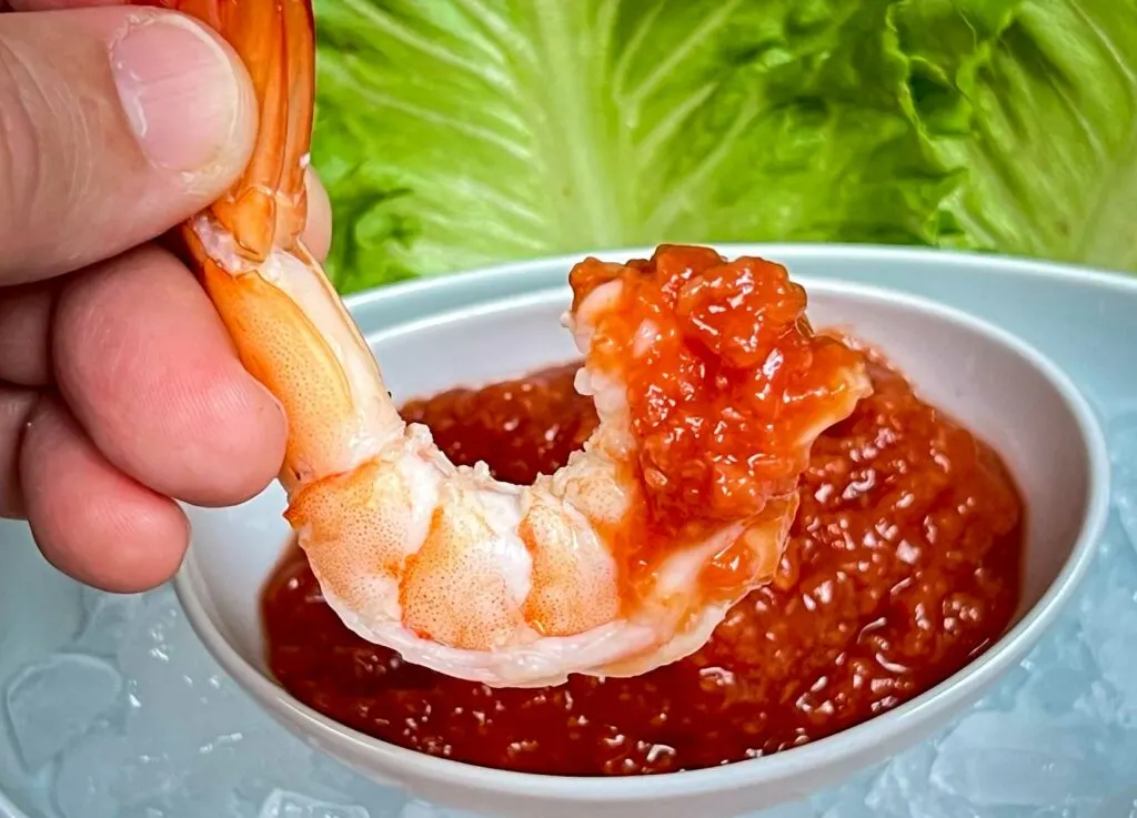 Shrimp dipped in cocktail sauce
