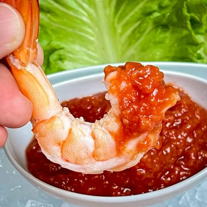Shrimp dipped in cocktail sauce