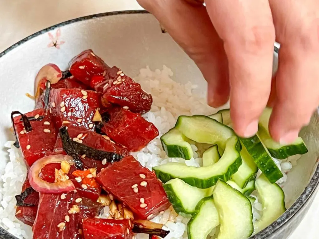 Placing Cucumbers into a Poke Bowl