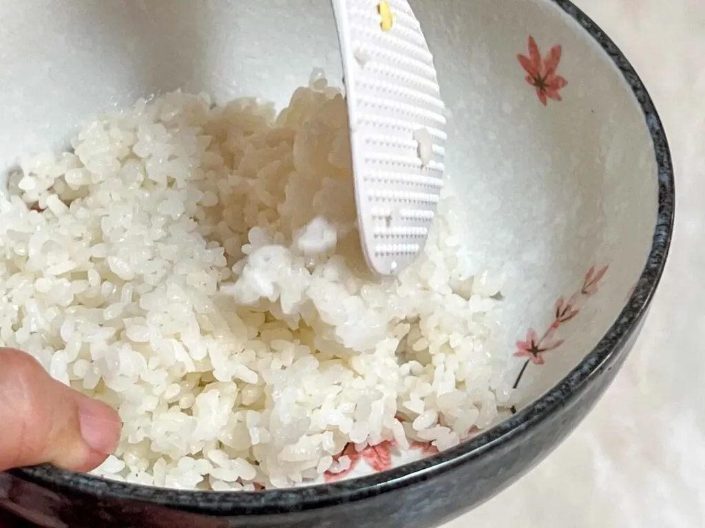 Placing Rice into a White Bowl