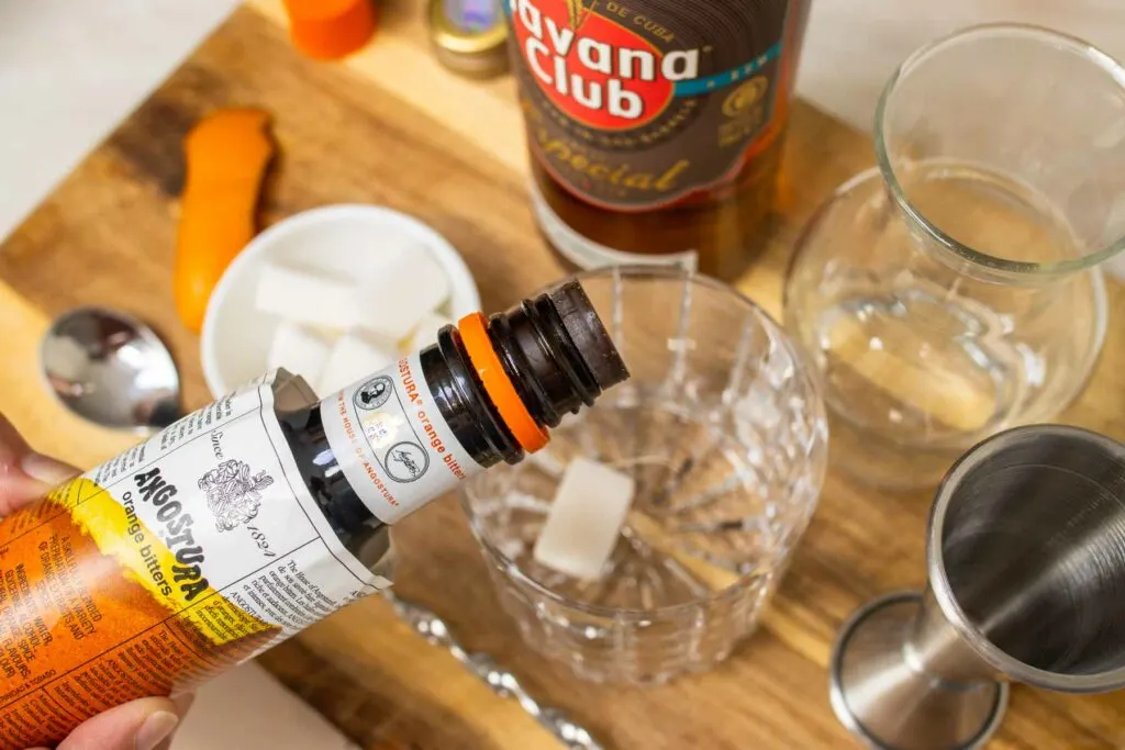 Adding Bitters to a Rum Old Fashioned Cocktail