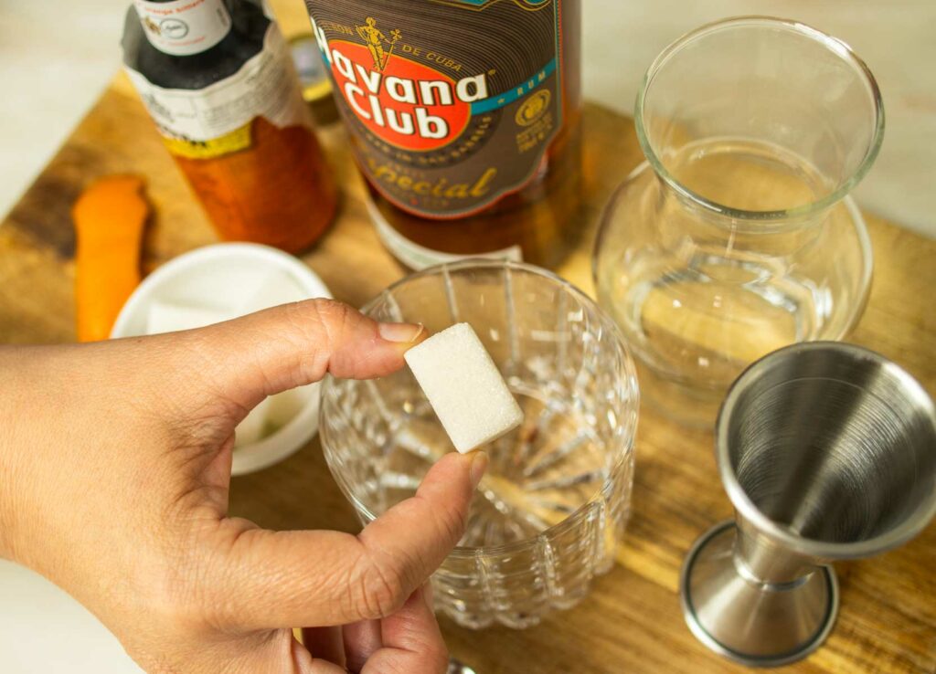 Adding a Sugar Cube to a Rum Old Fashioned Cocktail