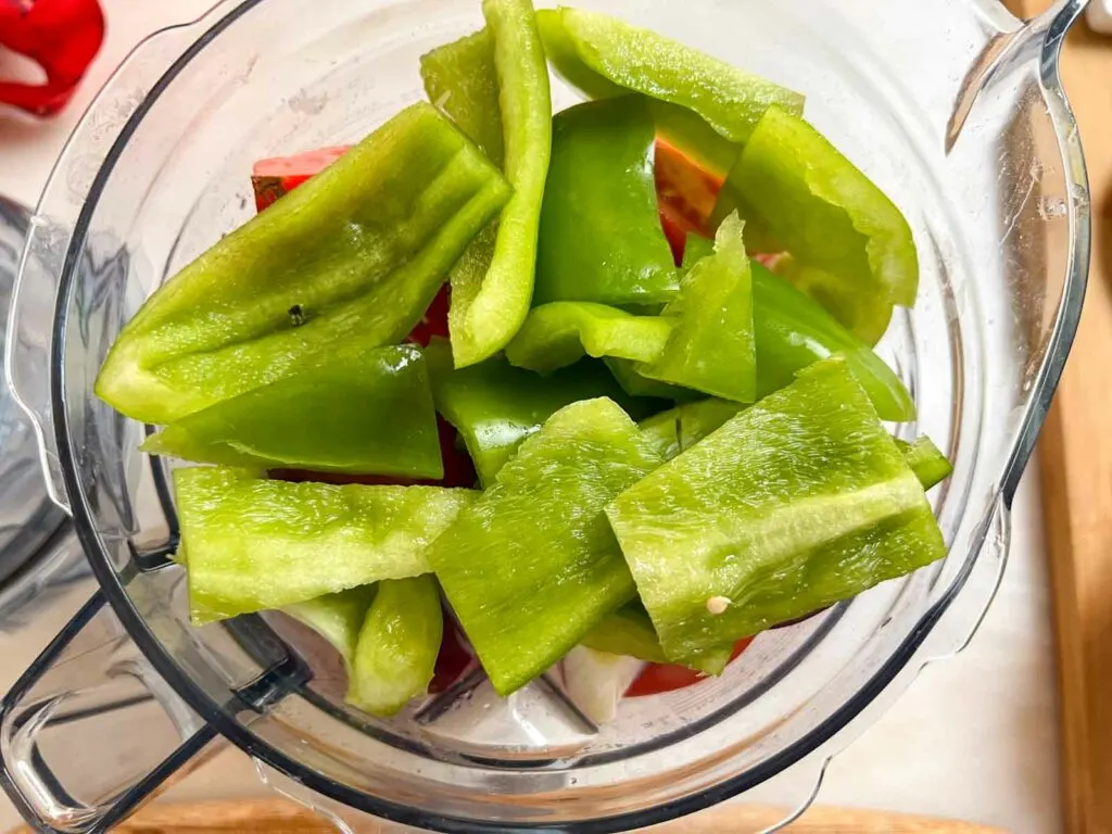 Chopped Green Bell Peppers sitting in a blender