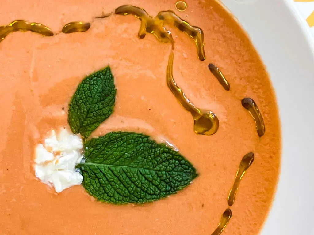 Closeup of gazpacho with mint and feta