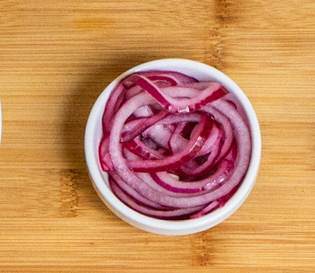 Pickled Rings of Red Onion in a White Bowl