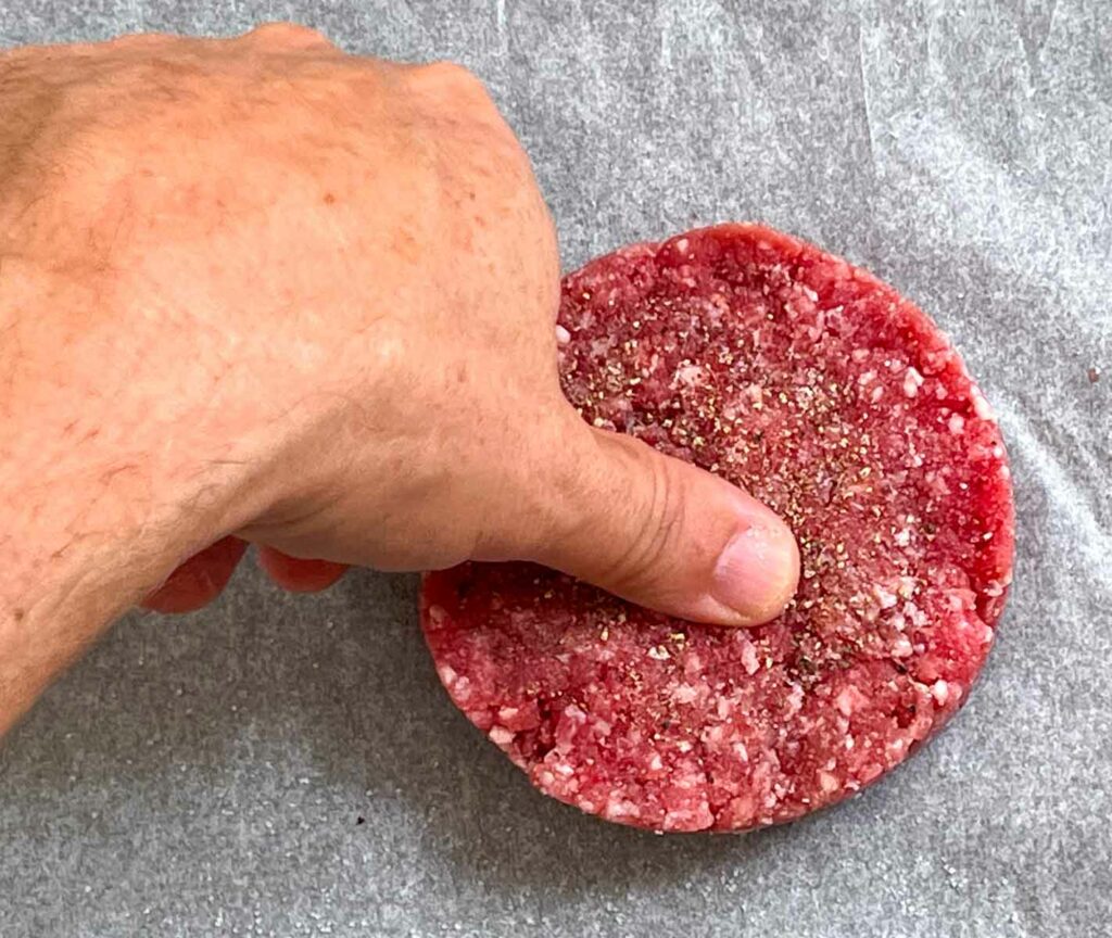 Placing an indentation into a hamburger before cooking