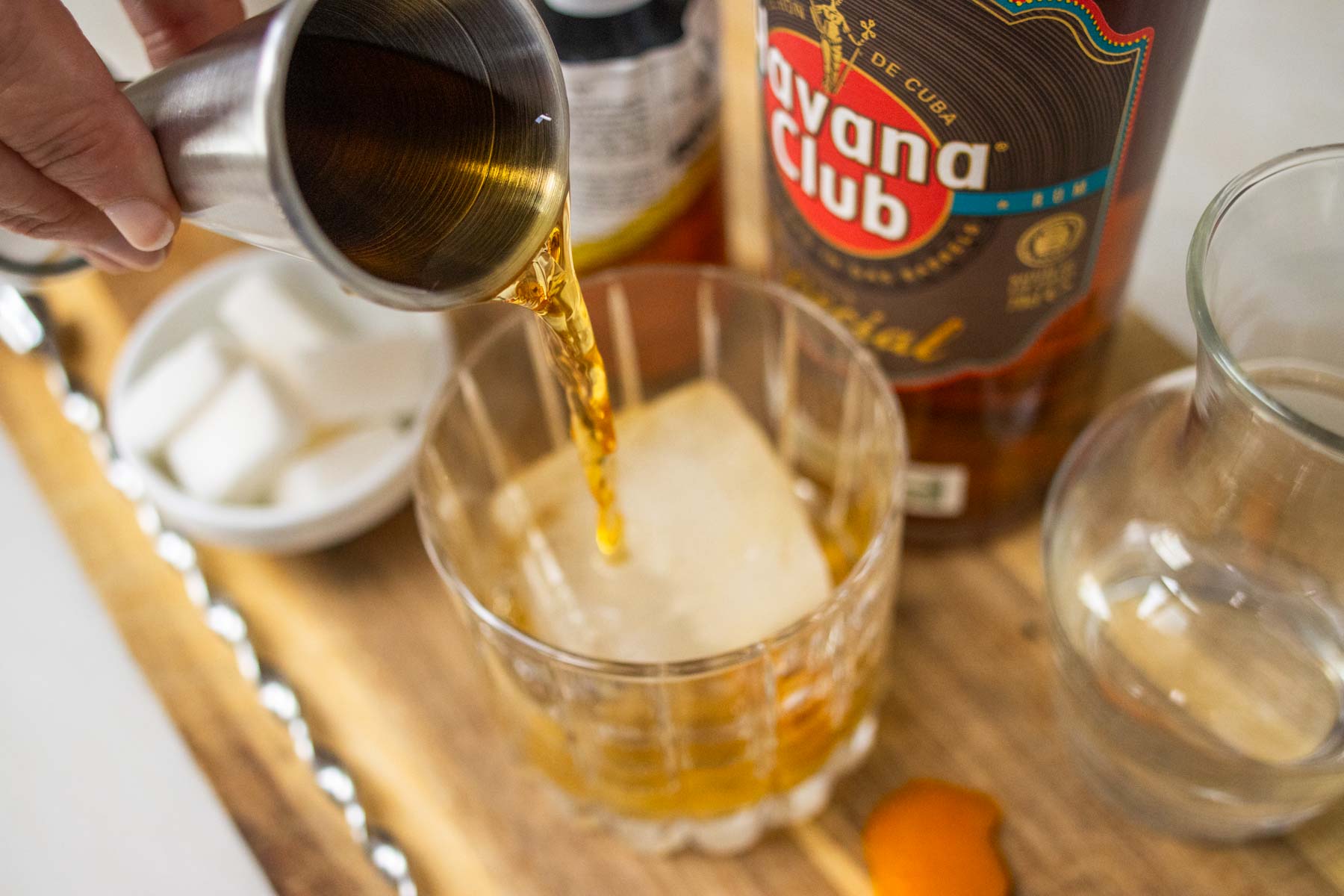 Pouring Rum into a Rum Old Fashioned Cocktail
