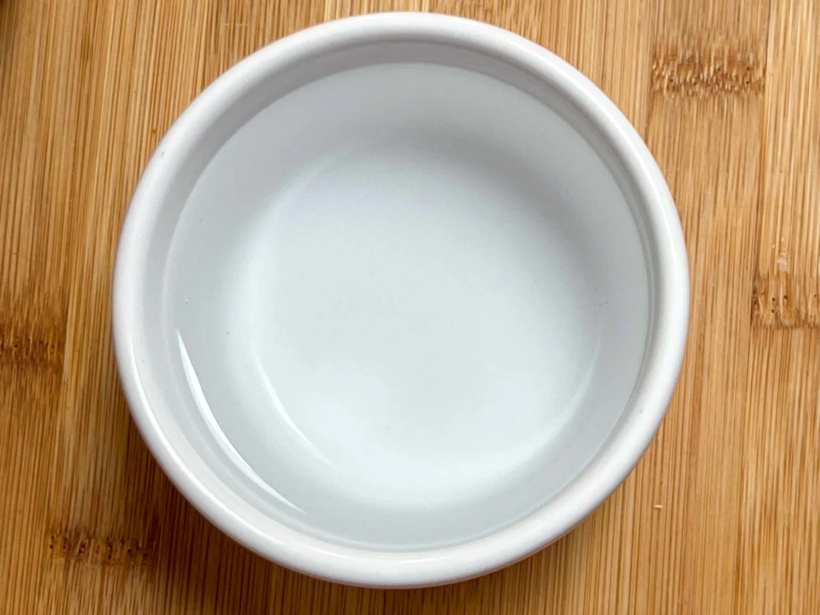 Water in a white ramekin
