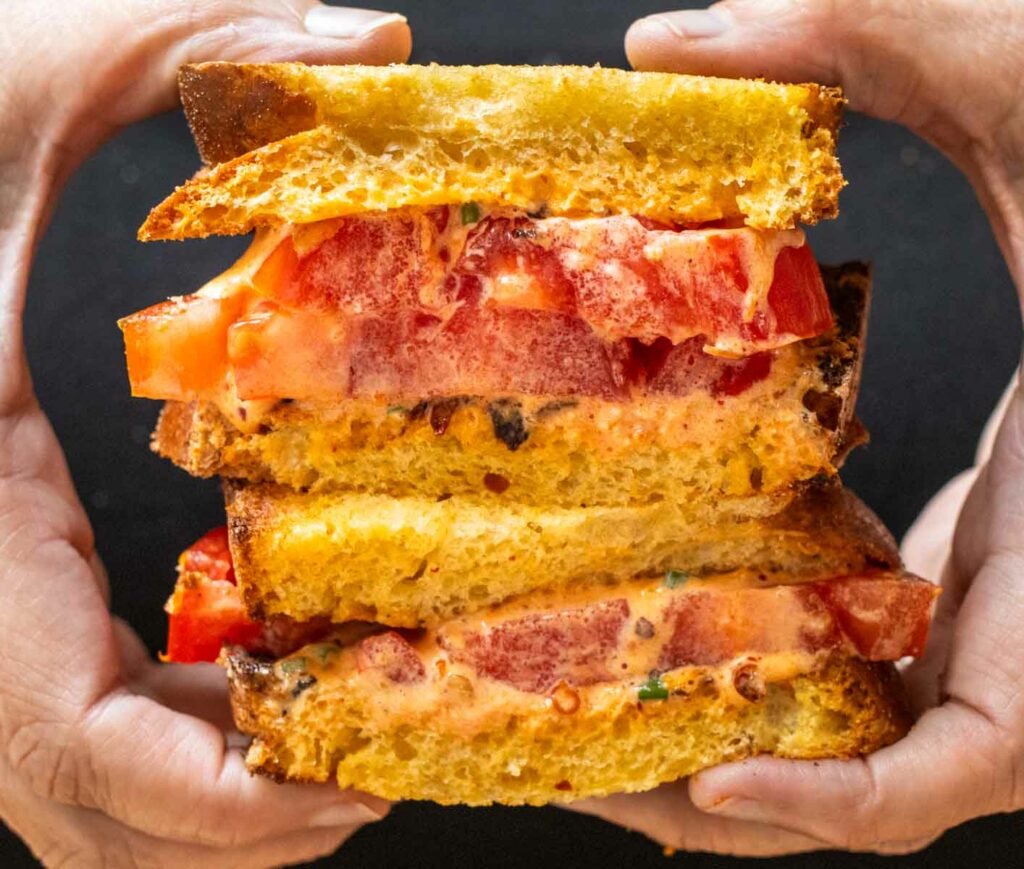 Holding a Tomato Sandwich