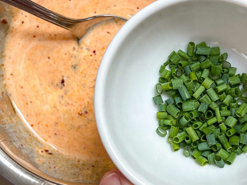 Mixing Chopped Chives into Chili Crisp Lime Mayo