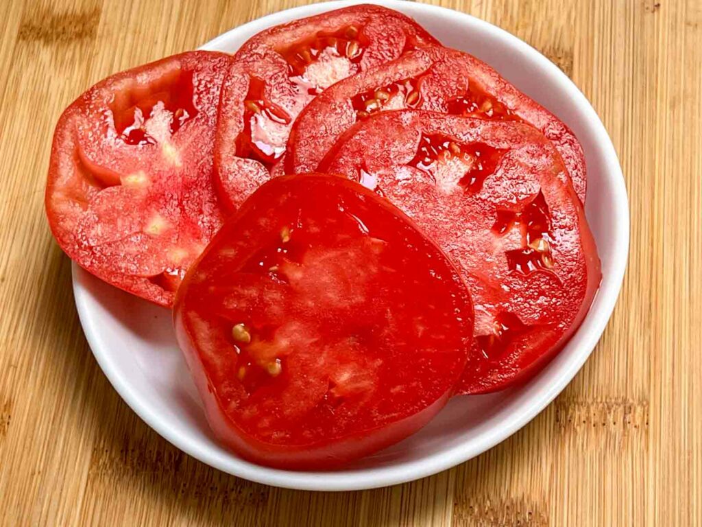 Sliced tomatoes on a white plate