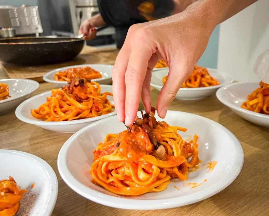 Plating Fettuccine Amatriciana at Pasta Making Class in Rome