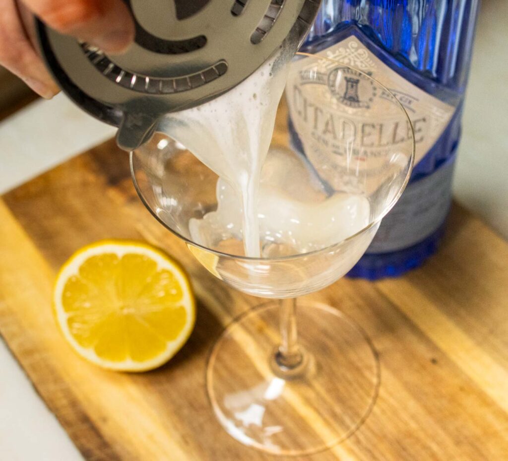 Straining Gin Sour Cocktail