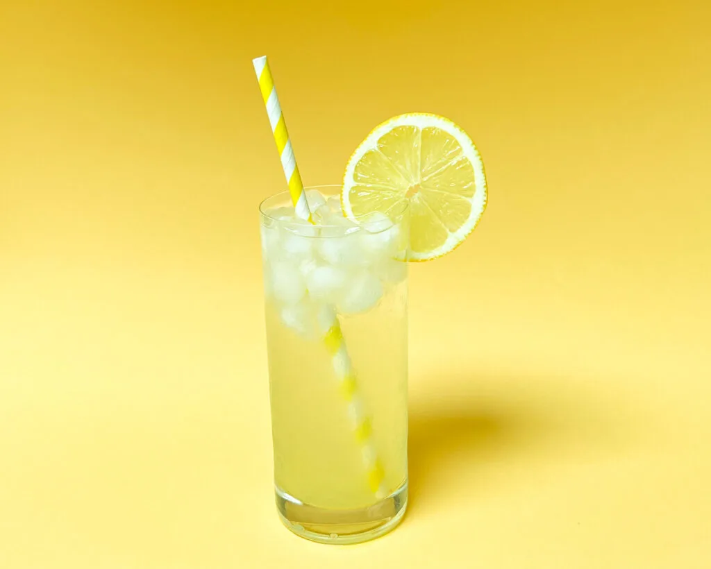 Tom Collins Cocktail with Yellow Background