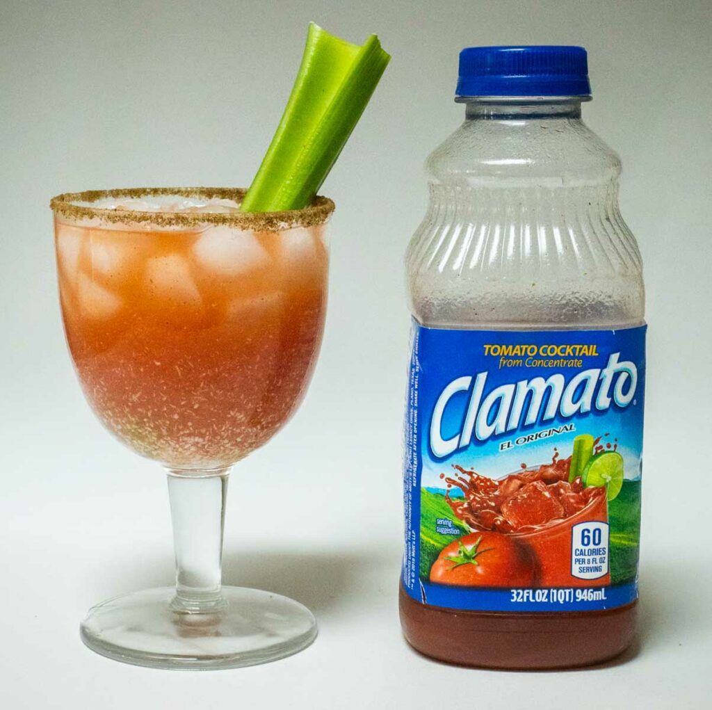 Bloody Caesar Cocktail Next to Clamato Juice Bottle