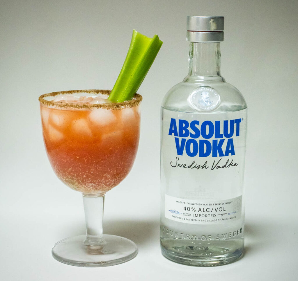 Bloody Caesar Cocktail Next to Vodka Bottle