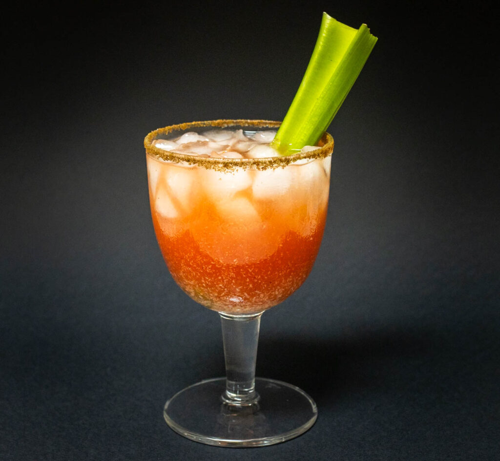 Bloody Caesar Cocktail with Celery and Black Background