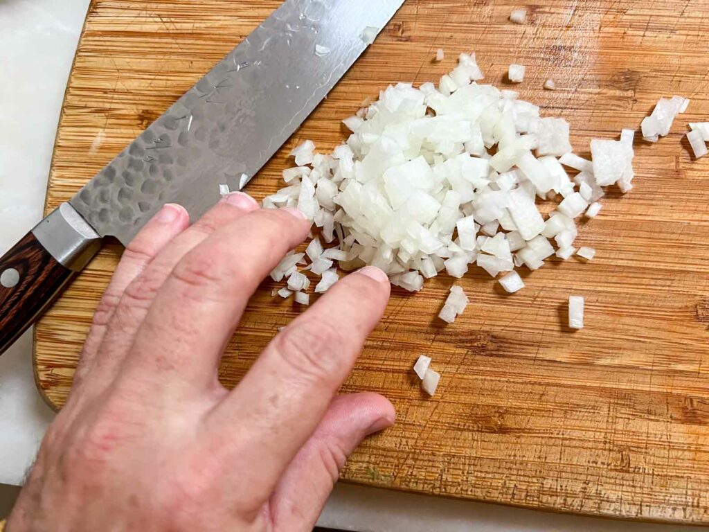 Diced onions on a wooden board