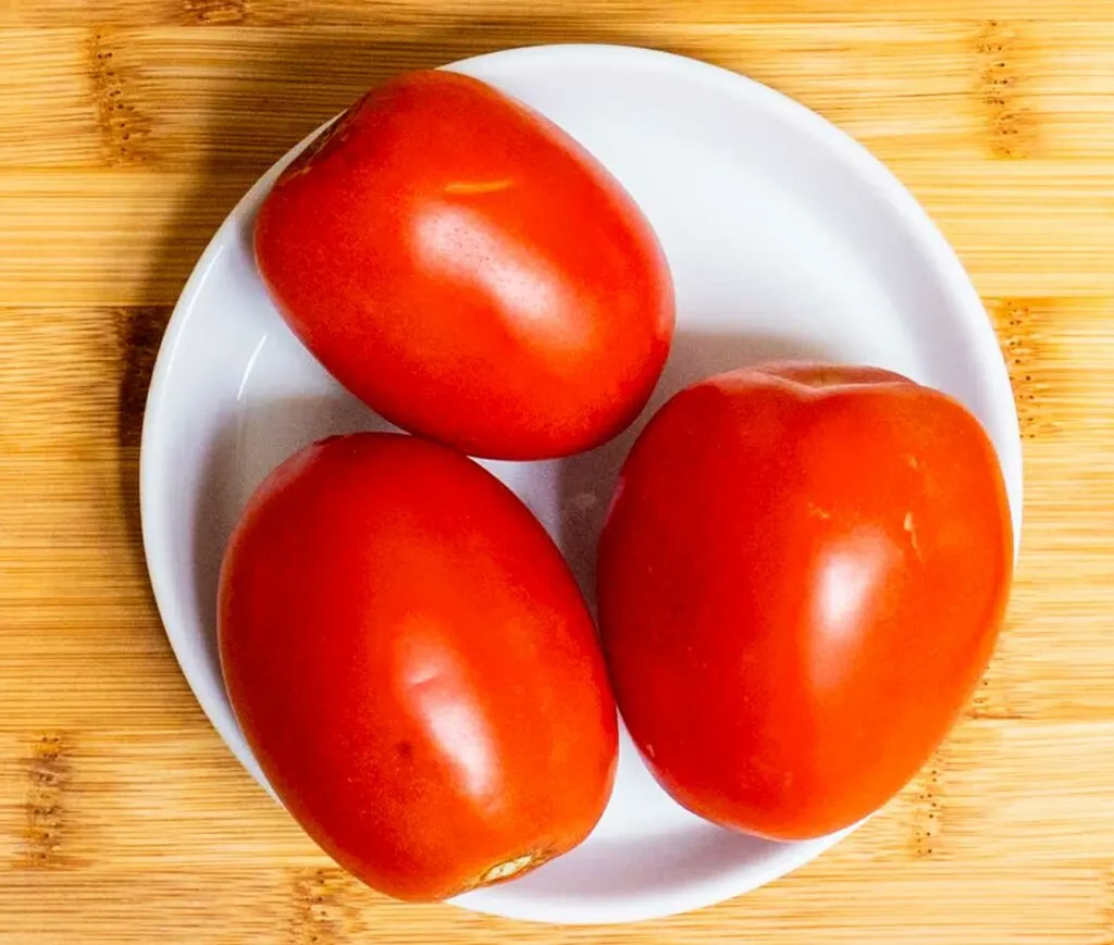 Red Plum Tomatoes on a White Plate