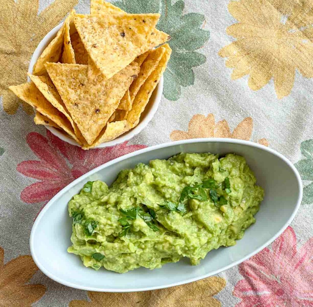 Guacamole and chips on a flower placemat