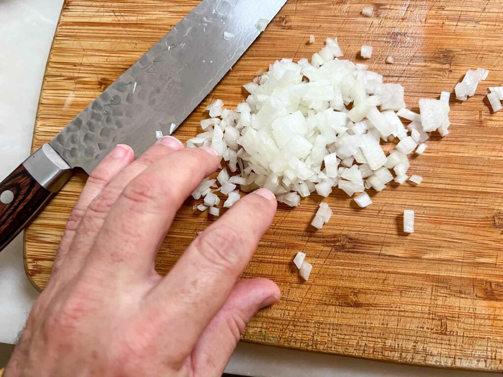 Minced Onions on a Wooden Cutting Board
