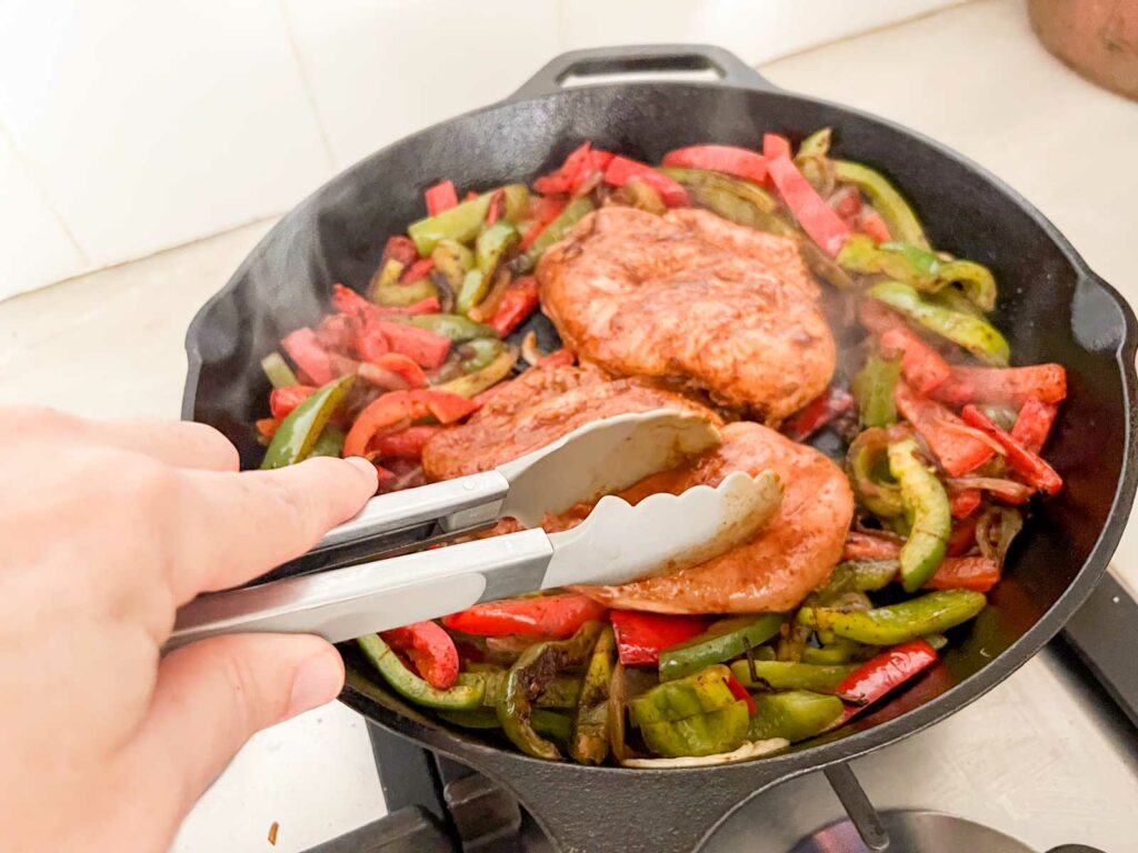 Pressing chicken during grilling in a cast iron skillet