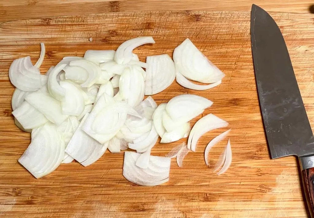 Sliced onions on a wood cutting board