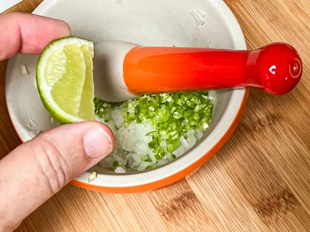 Squeezing Lime into a Mortar and Pestle for Guacamole