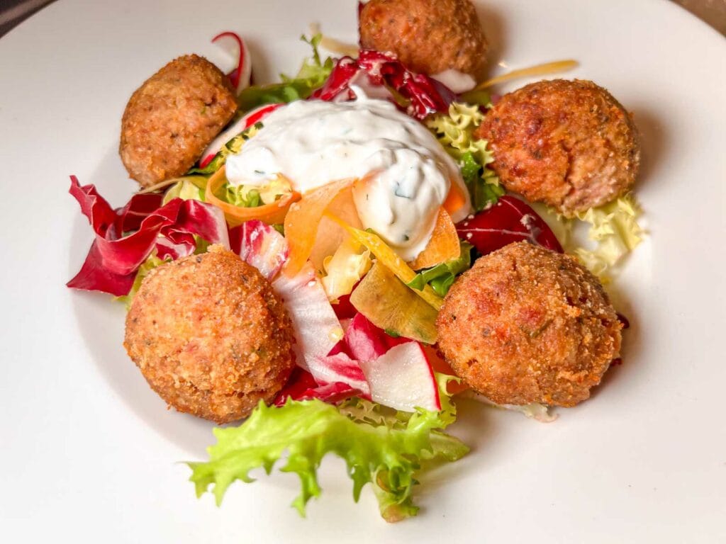 Roasted Meatballs with Mixed Salad and Yogurt Sauce at Trattoria Mirta in Milan