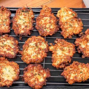 Passover Salt Cod latkes draining on a cooling rack