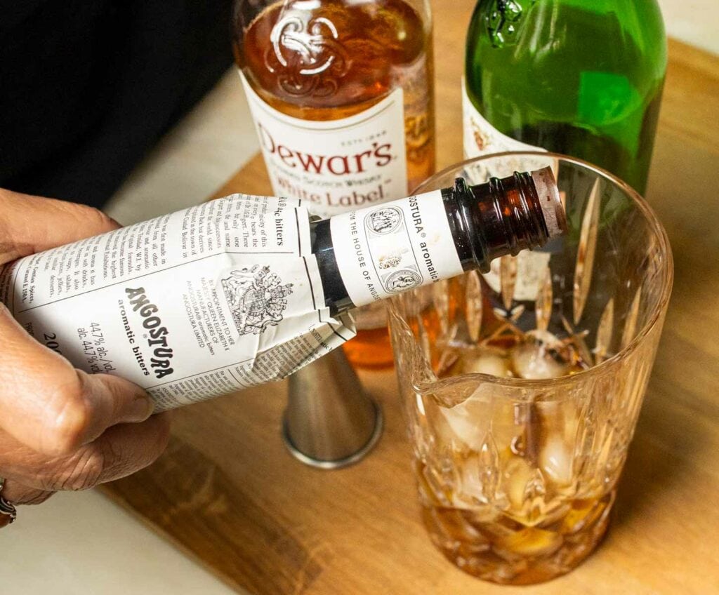 Adding Bitters to a Rob Roy Cocktail