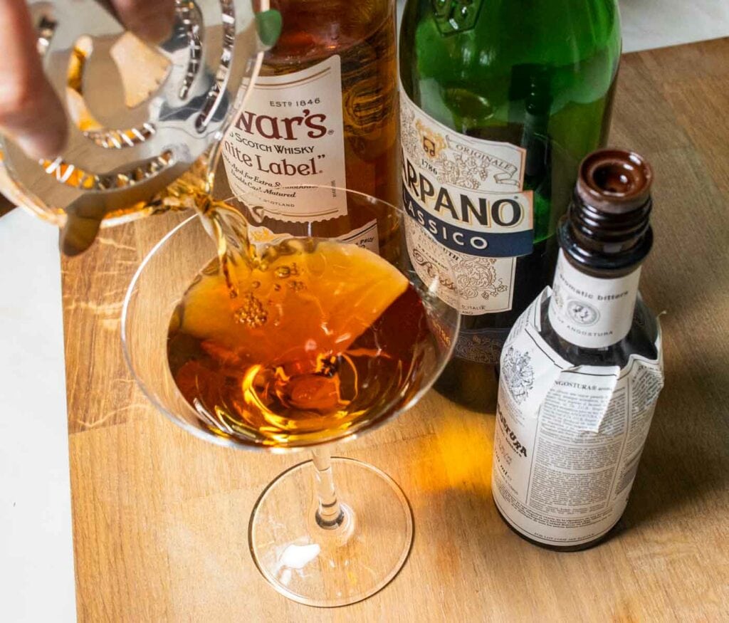 Straining a Rob Roy Cocktail