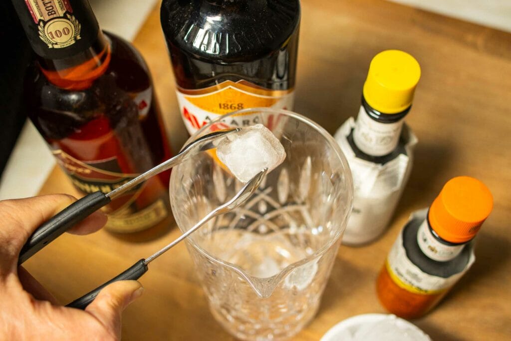 Adding Ice to a Mixing Glass for a Black Manhattan