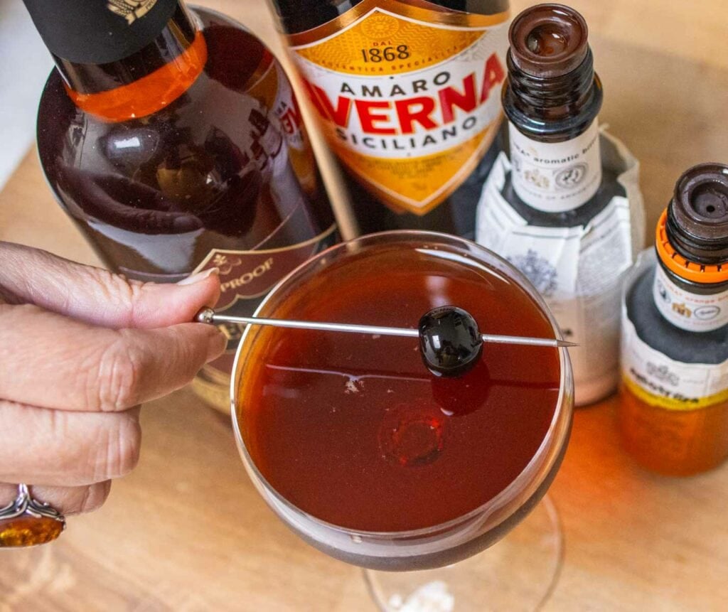 Garnishing a Black Manhattan Cocktail