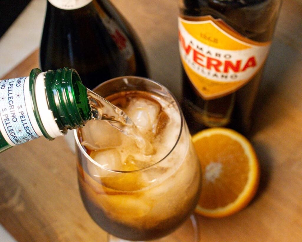 Pouring Sparkling Water into an Averna Spritz